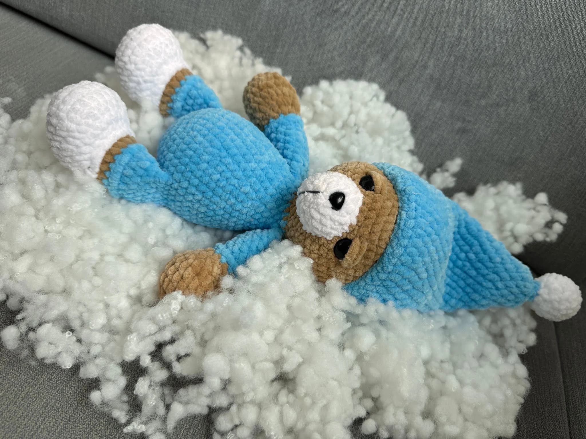 Ръчно плетено мече в синьо върху пухкаво одеялце от CuddleCraft